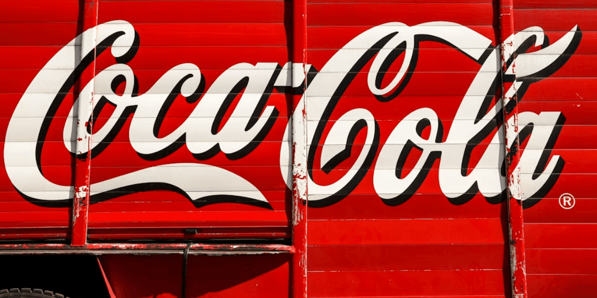Coca-Cola logo displayed on the side of a red delivery truck.