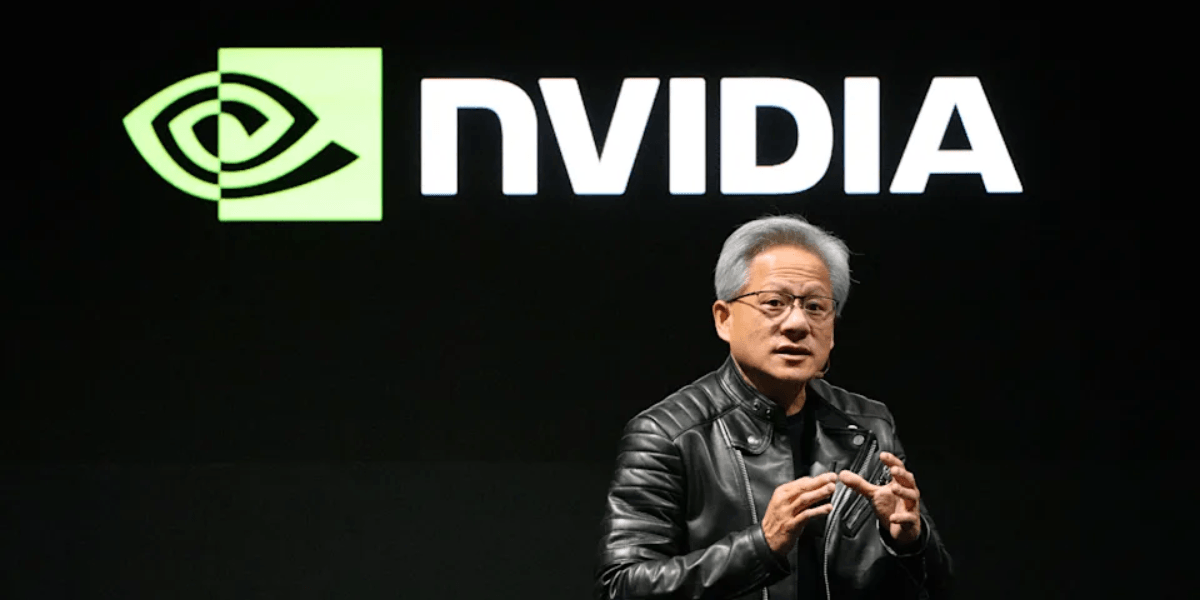 A speaker in a black leather jacket presents in front of an NVIDIA logo