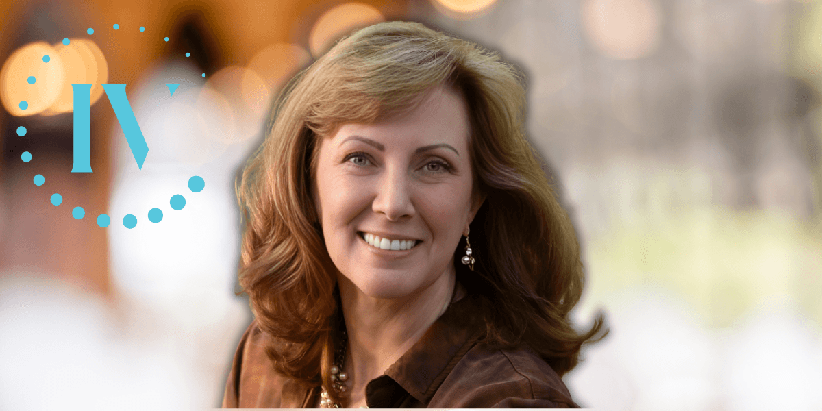 Carey Mencarini, founder of IV Lounge, smiling in a professional portrait with blurred background celebrating wellness achievement.