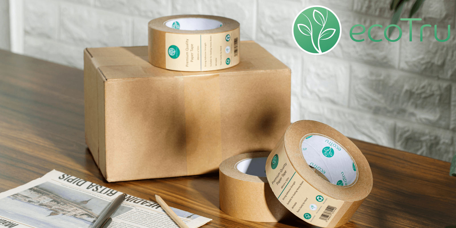 ecoTru sustainable packaging tape and boxes on a wooden surface, showcasing eco-friendly products for businesses and homes."