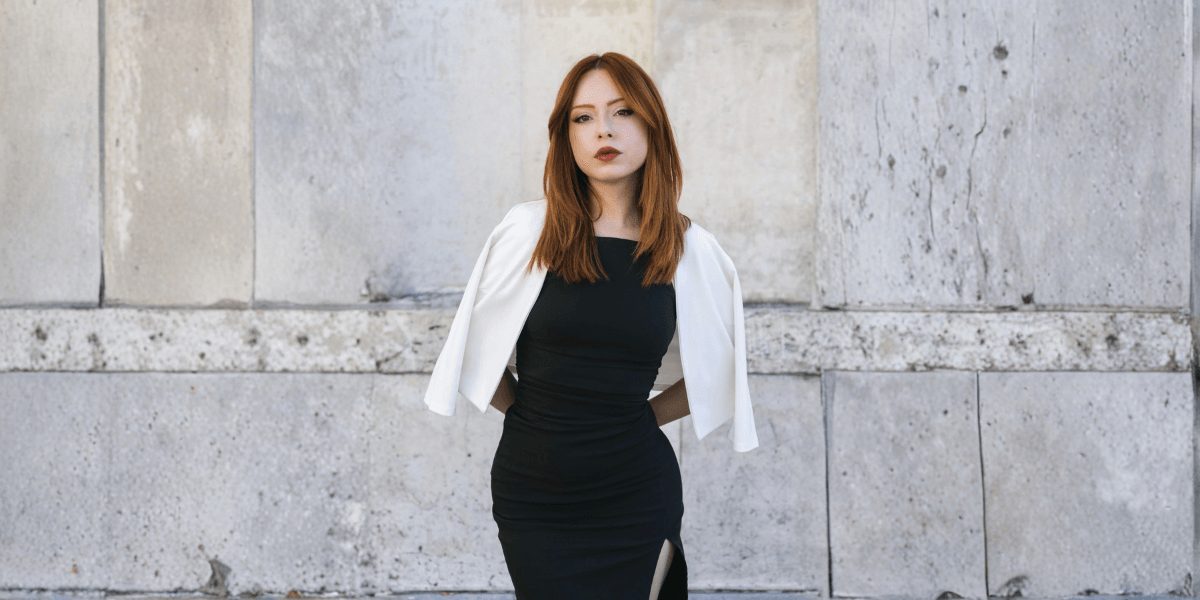 Derin Zanbak, founder of Altum, stands confidently in a black dress, embodying elegance and strength in Paris.