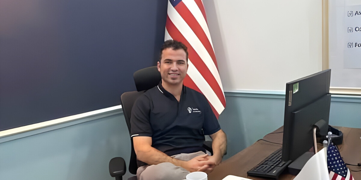 Founder Sarbaz Hassan of Hello Services seated at his desk, leading the expansion of HelloCleaners.us across the US.