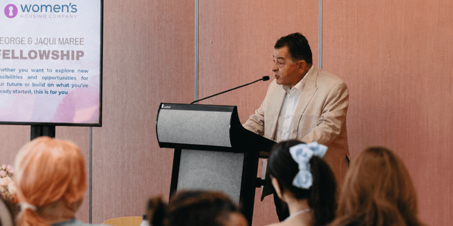 George Stamas addresses attendees during the Women’s Housing Company Fellowship event.