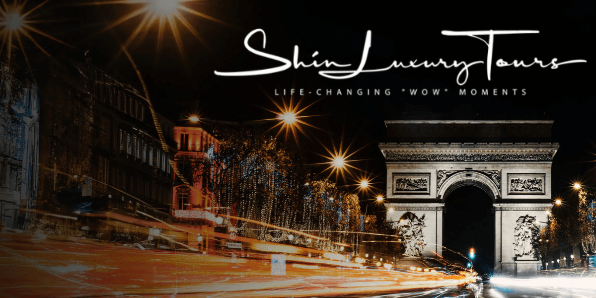 Arc de Triomphe illuminated at night with light trails, representing a luxury experience in France by Shin Luxury Tours.
