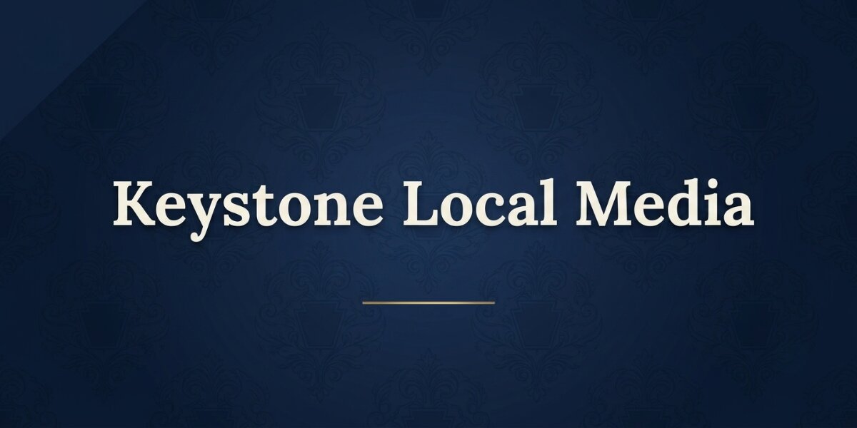 Keystone Local Media logo displayed on a dark blue patterned background with centered white text.