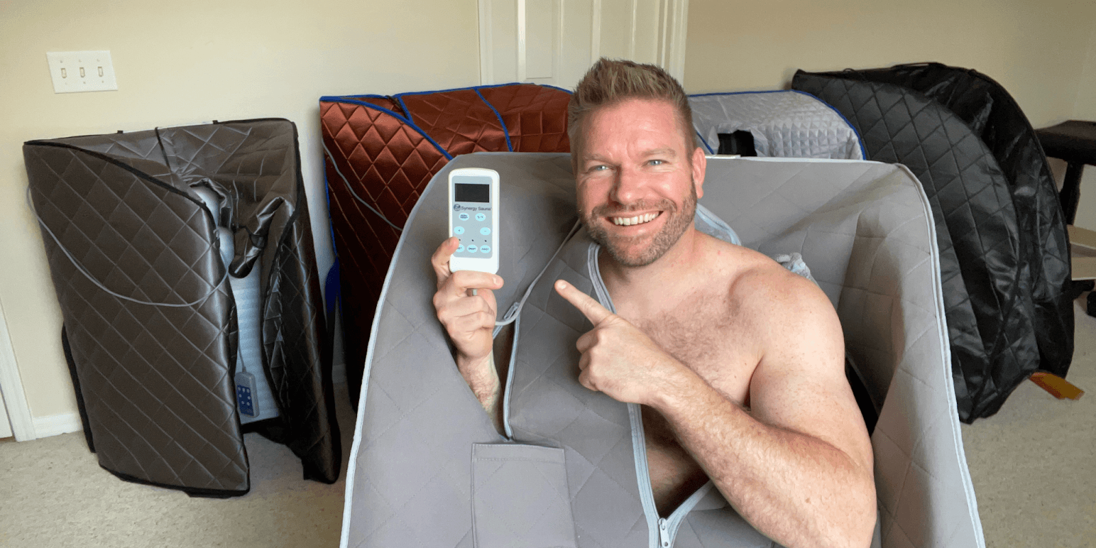 Matt Justice, founder of CertifiedSaunas.com, demonstrating an infrared sauna and holding the control panel. The image highlights his commitment to promoting sauna detox for health recovery, showcasing his expertise in the wellness industry and dedication to providing trustworthy resources for detoxification.