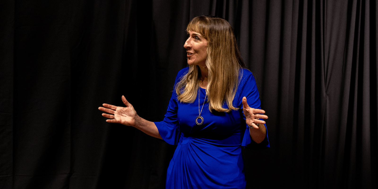 Maria Garaitonandia, a leadership communication strategist, delivering a speech on improving communication in organizations.