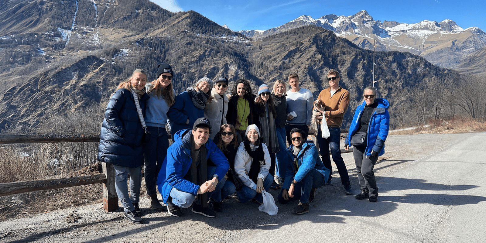 A team of professionals participating in a nature-based corporate retreat, enhancing collaboration, creativity, and trust amidst stunning mountain landscapes