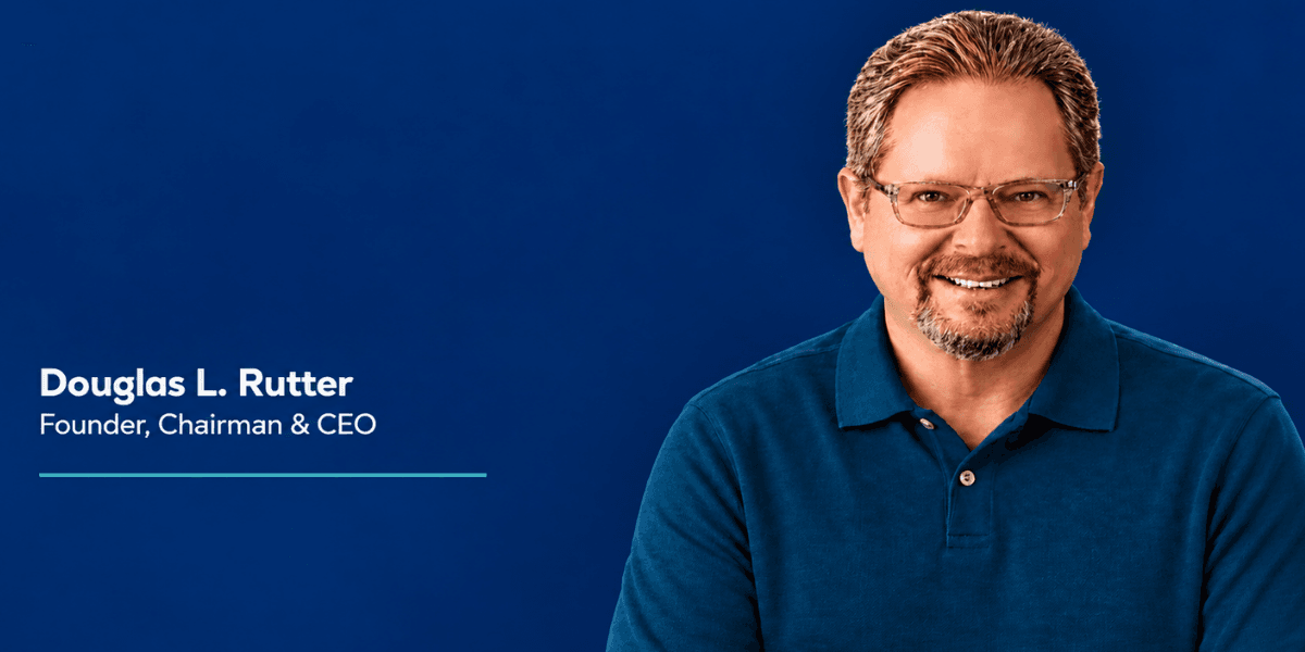 Smiling man in a blue shirt against a blue background, labeled as CEO.