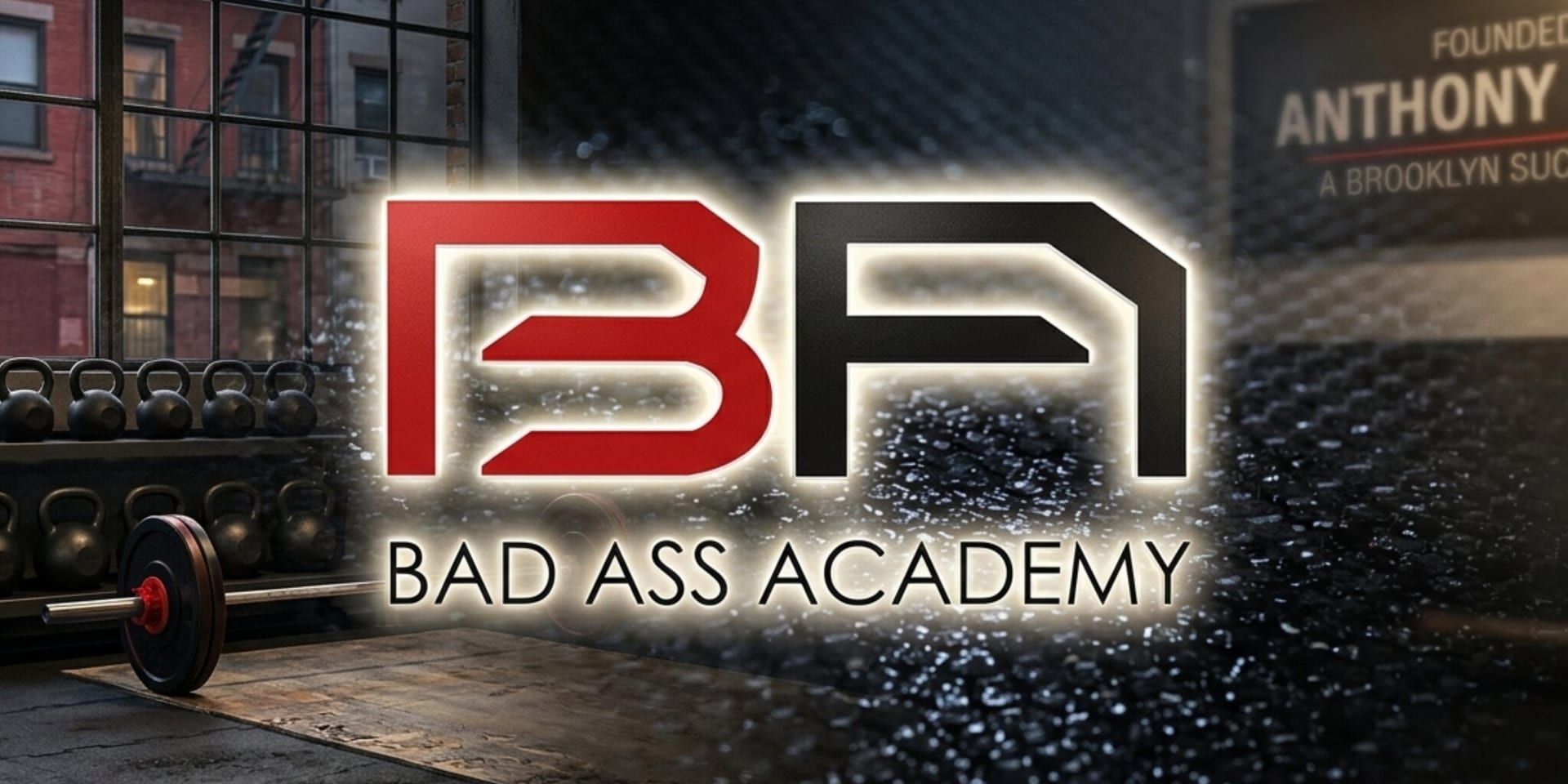 Bad Ass Academy logo inside a Brooklyn functional training gym with kettlebells and a barbell.
